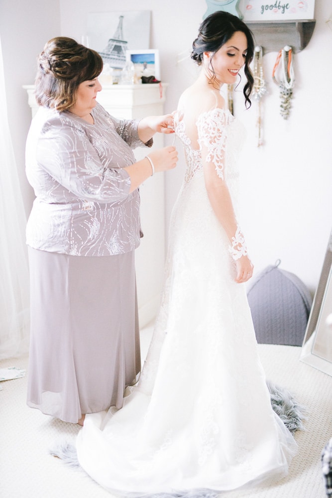 Mom doing up wedding dress