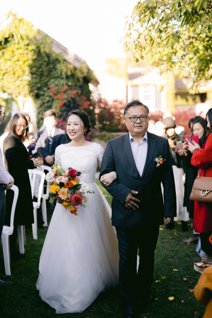 Father walking Bride down the isle in the Rose Garden in Niagara on the lake