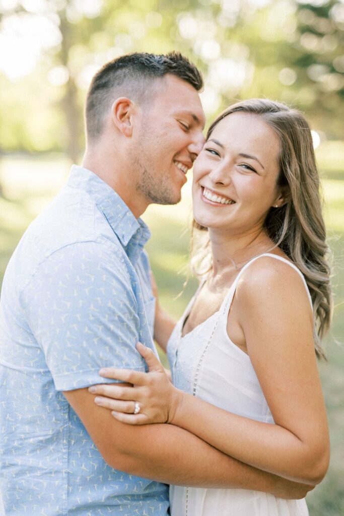 Couple smiling for engagement photo in spring by Niagara Wedding Photographer