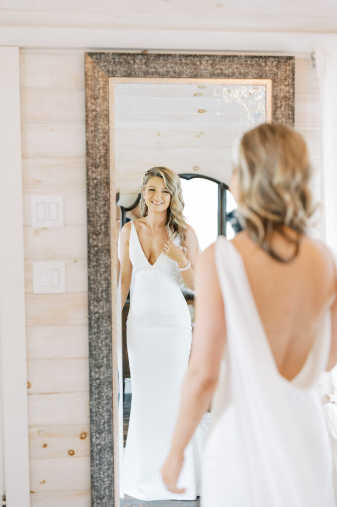 Bride looking at herself in the mirror in the bridal cottage at Stonewall Estate Winery 