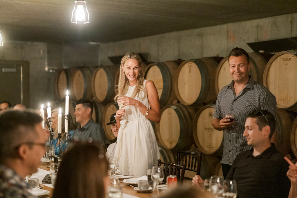 Bride and Groom giving toast at rehearsal dinner at Ravine Estate Winery By Niagara Wedding Photgorapher