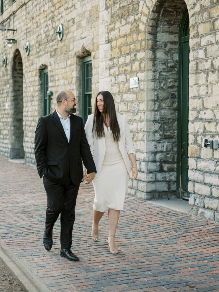 Engaged couple in historic distillery district in Toronto in spring